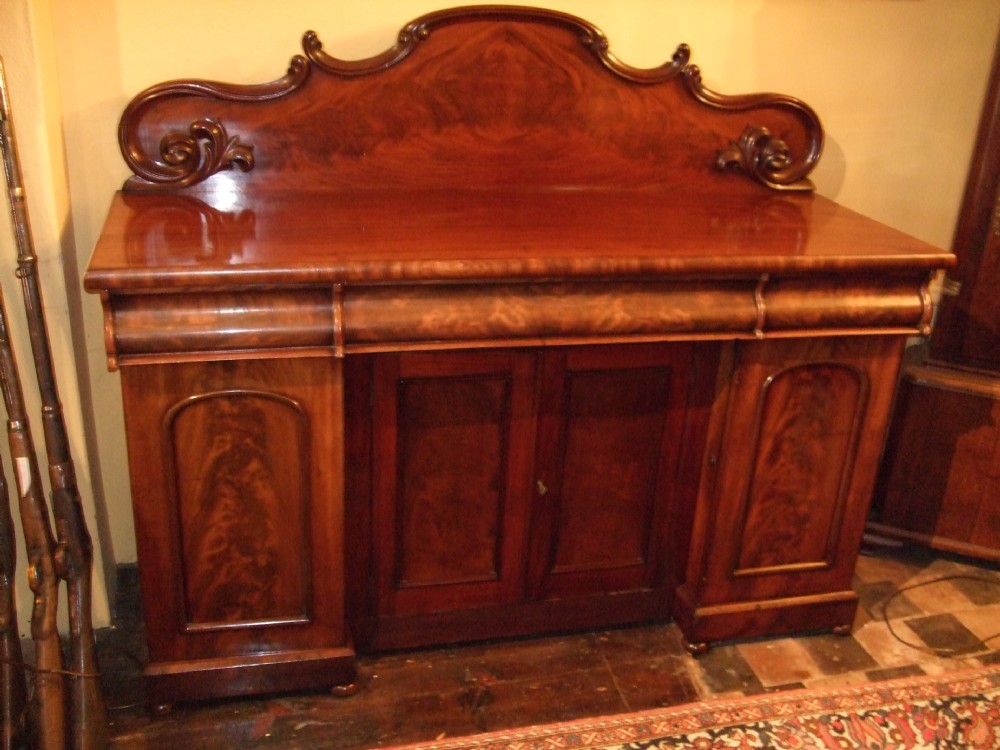 mid victorian flame mahogany four door sideboard with cellarette slides