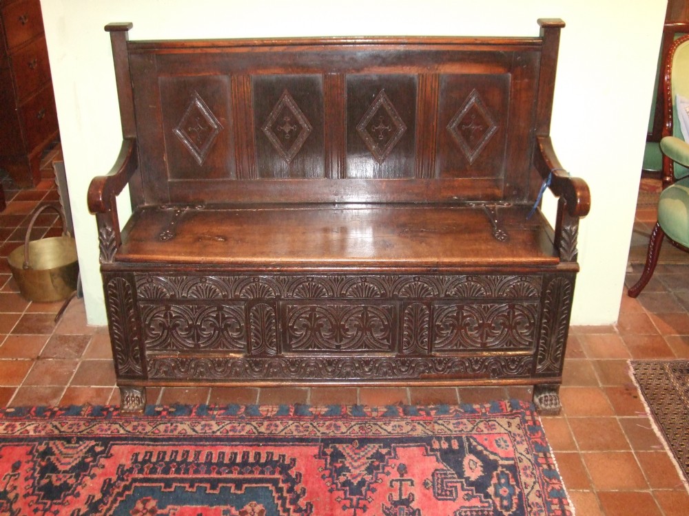 late 18thc oak settle with iron strap hinges carved decoration