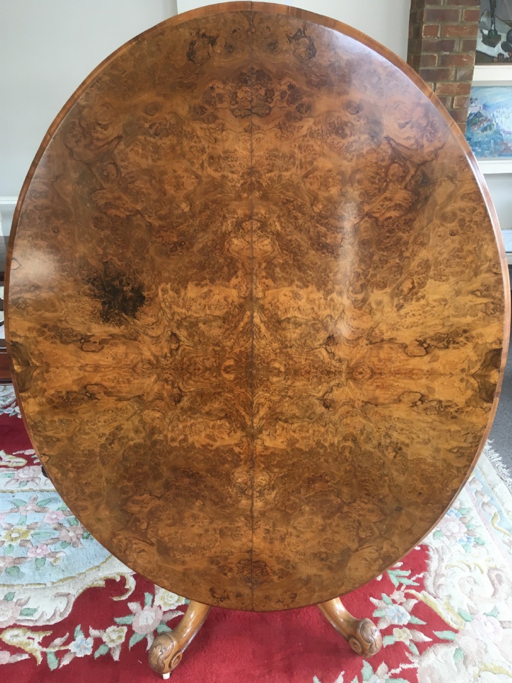 victorian burr walnut tilttop diningcentre table on carved pedestal with floral decoration